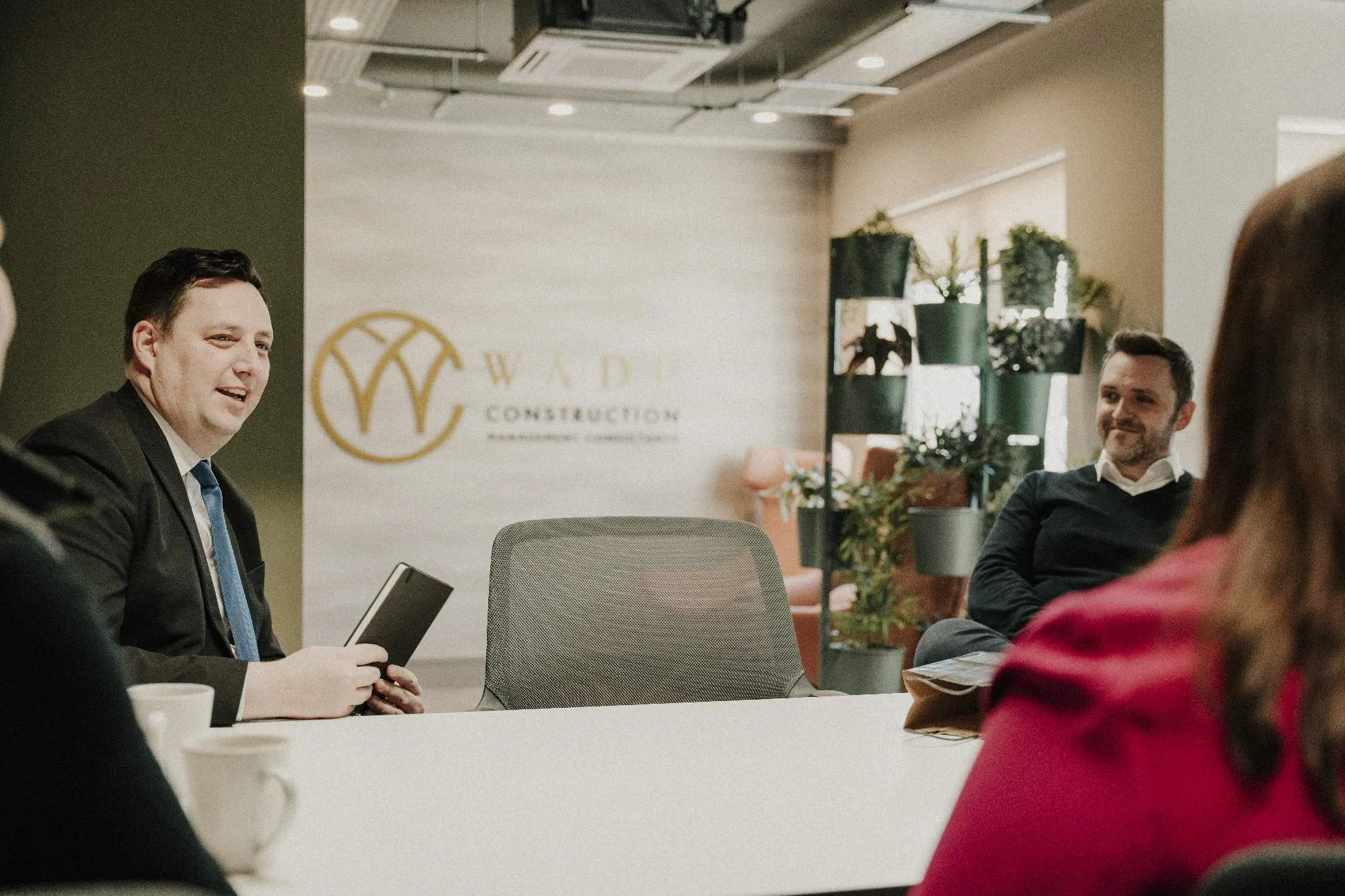 Image of Ben Houchen at a white table in the Wade offices in Darlington. Daniel Wade sits with him, both men are smiling.